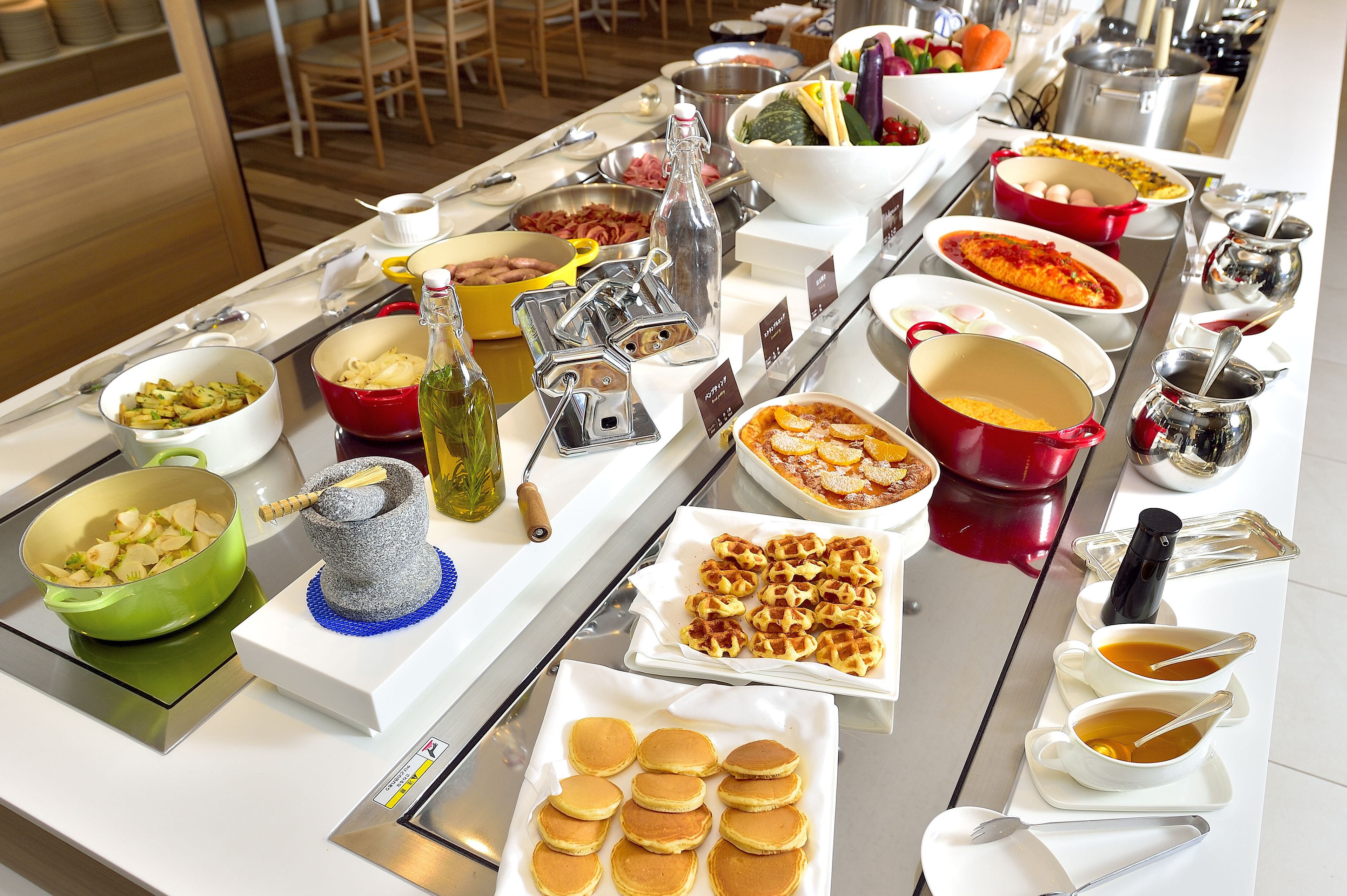 A buffet with various dishes and beverages.