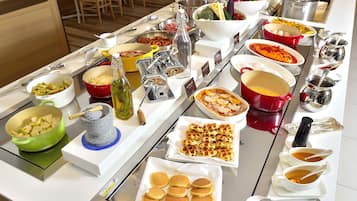 A buffet with various dishes and beverages.