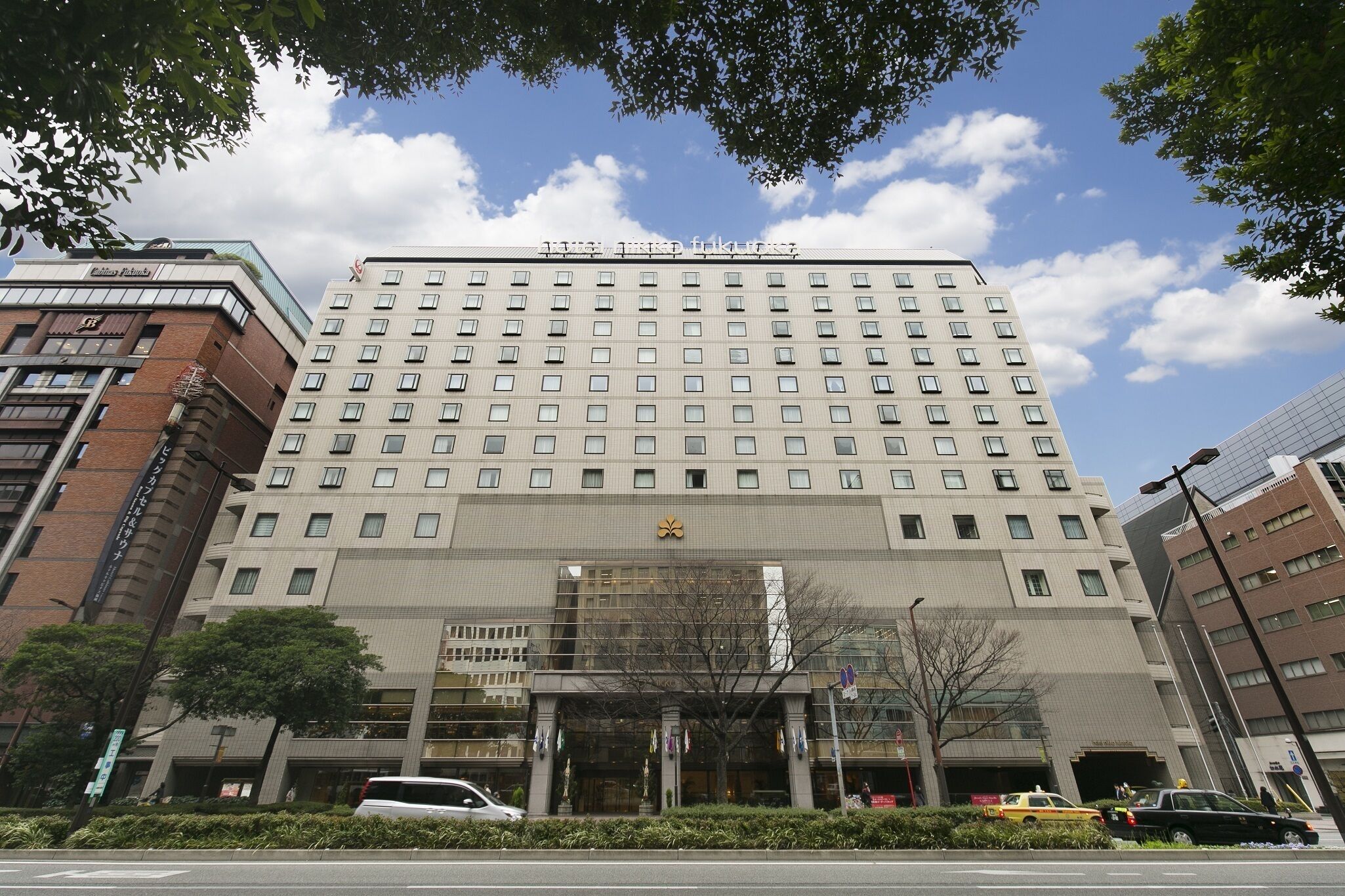 A multi-story hotel with a prominent entrance and a large sign above the doors.