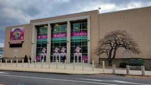 A brick building with large windows and a banner for the 1st Summit Arena. - Holiday Inn Johnstown Downtown by IHG (Johnstown)