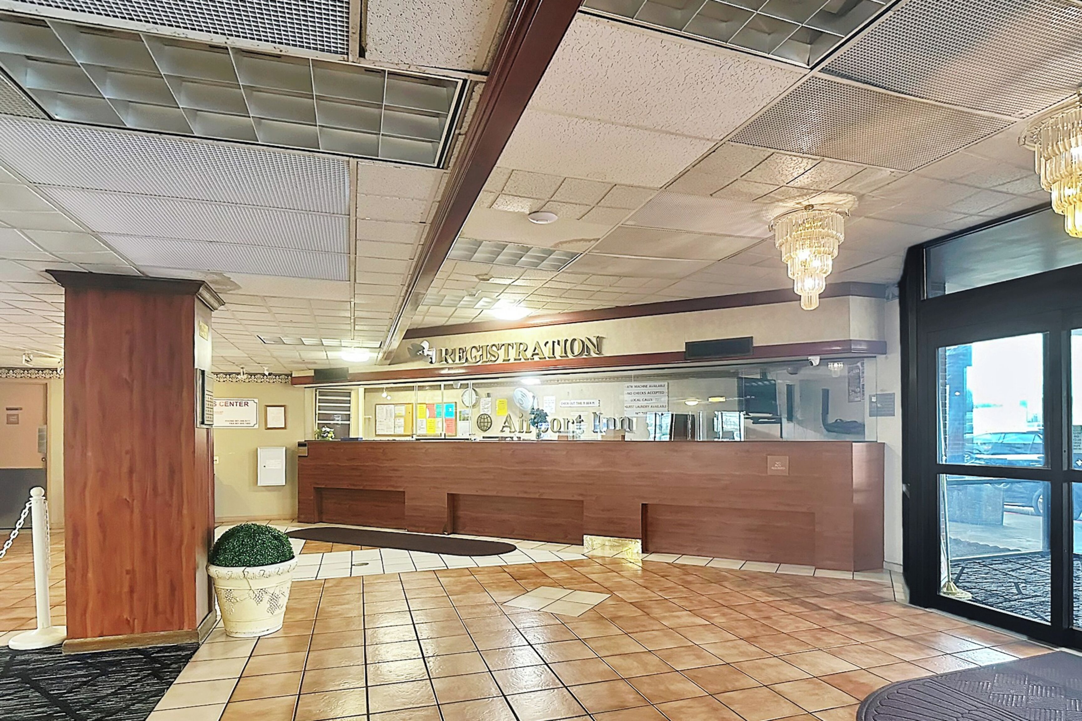 A reception area with a wooden counter, a sign reading 'Registration,' and a large window.