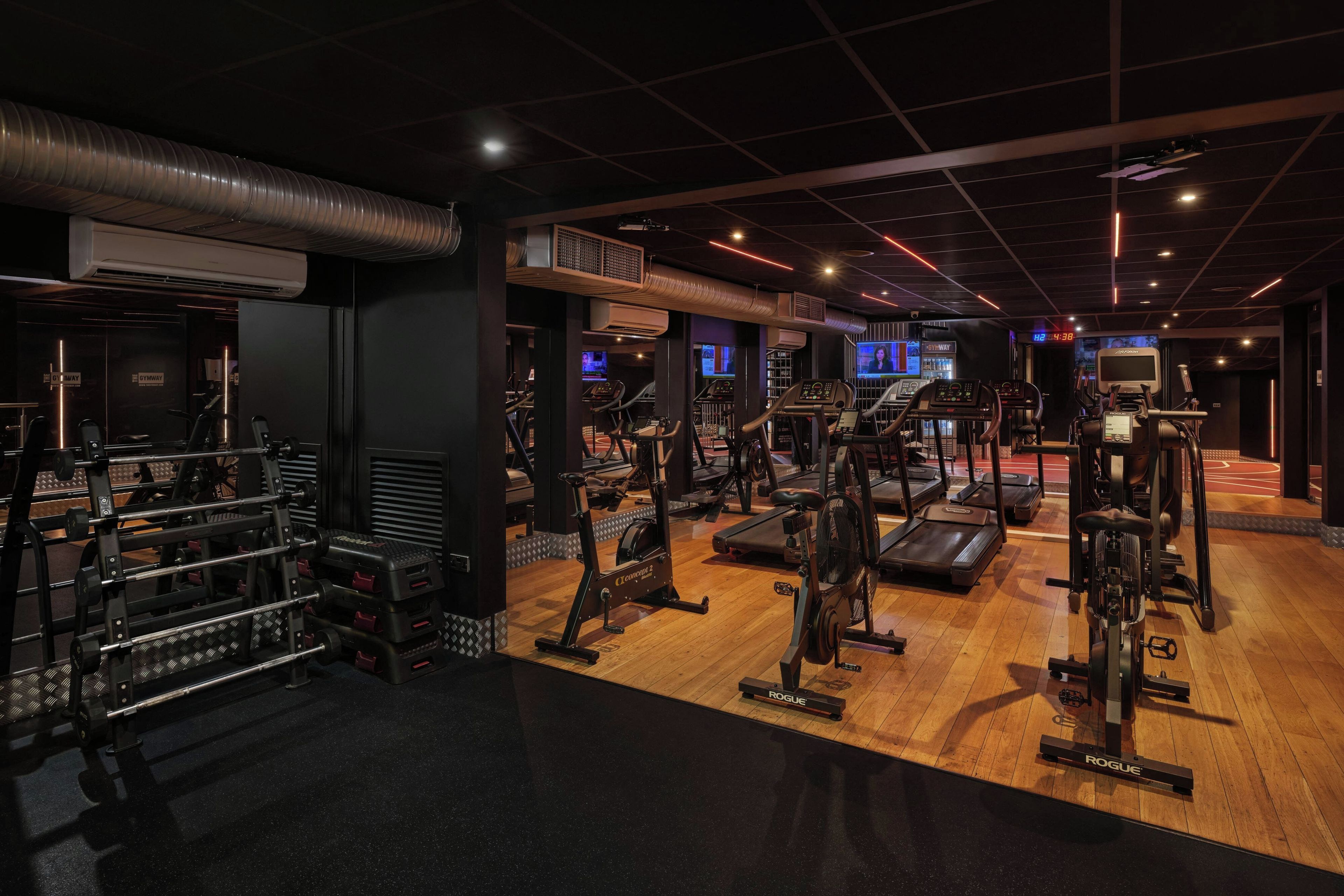 A gym with various exercise equipment, including treadmills and weight machines.