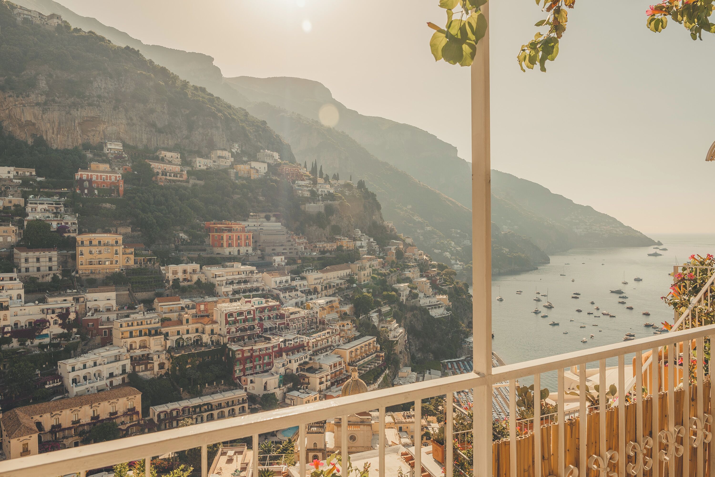 A coastal town with buildings on a hillside overlooking the sea.