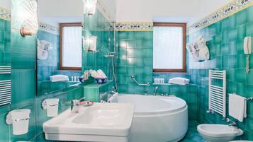 A bathroom with a bathtub, a sink, and a toilet.