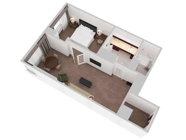 A 3D floor plan of a hotel room with a bed, bedside table, lamp, and a small seating area with a table and chairs.