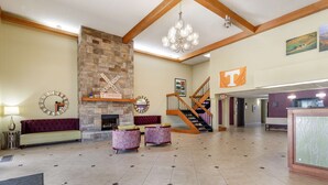 A spacious lobby with a stone fireplace, a staircase, and a reception desk. - Best Western Plus Knoxville Cedar Bluff (Knoxville)