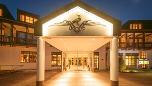 A hotel entrance with a prominent logo, a covered walkway, and a well-lit facade. - Dorint Venusberg Bonn (Bonn)