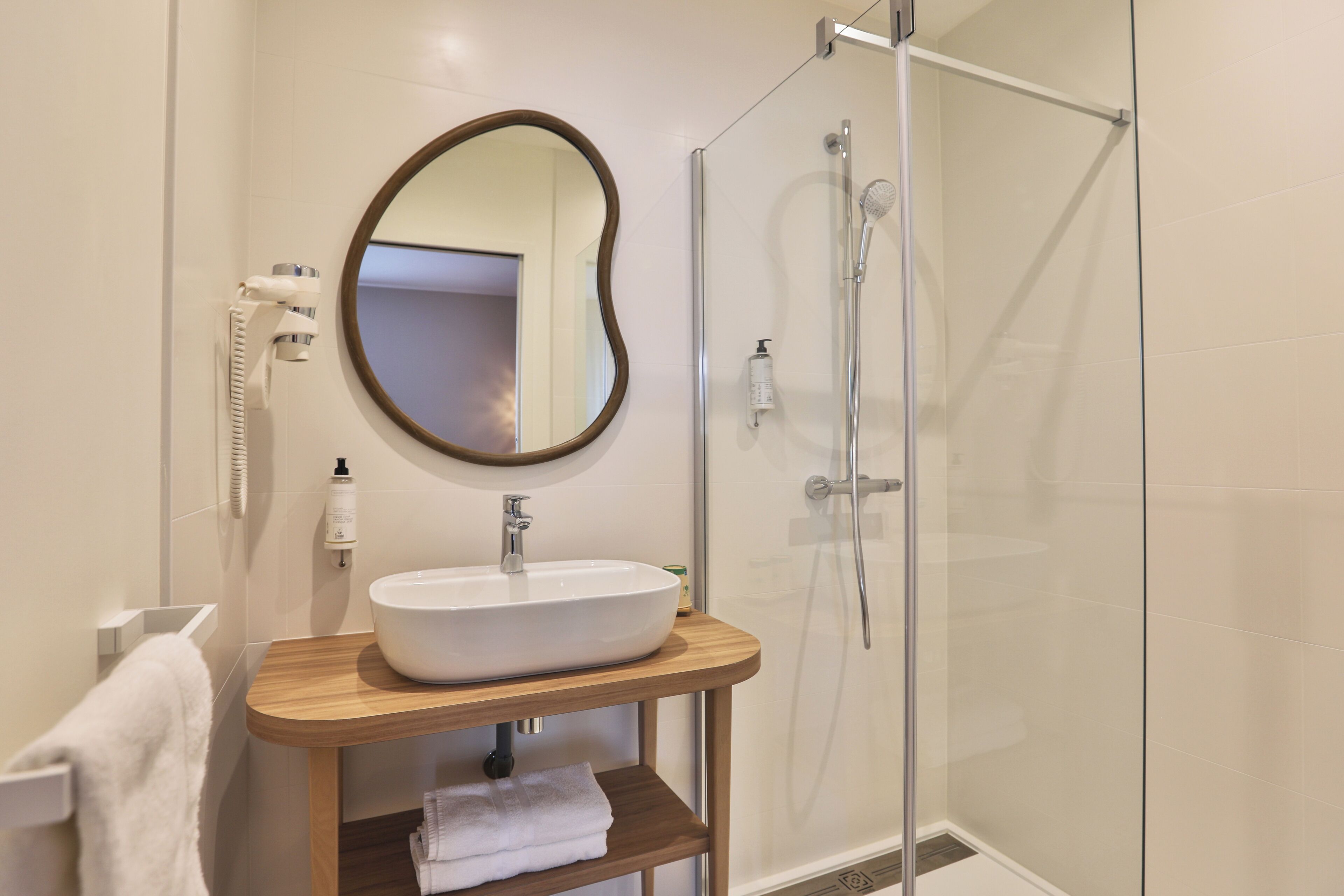 communicating rooms street side | bathroom | hair dryer, towels, soap, shampoo