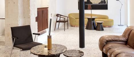 A modern living room with a sectional sofa, a round coffee table, and a minimalist design.