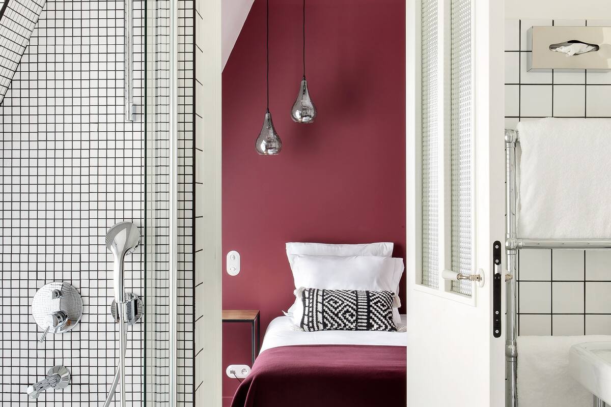 A modern bathroom with a shower, a toilet, and a sink.