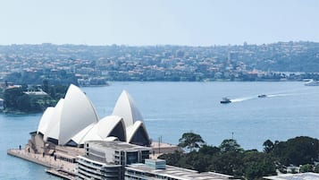 A waterfront hotel with a distinctive architectural design, featuring a curved building and a prominent waterfront view.