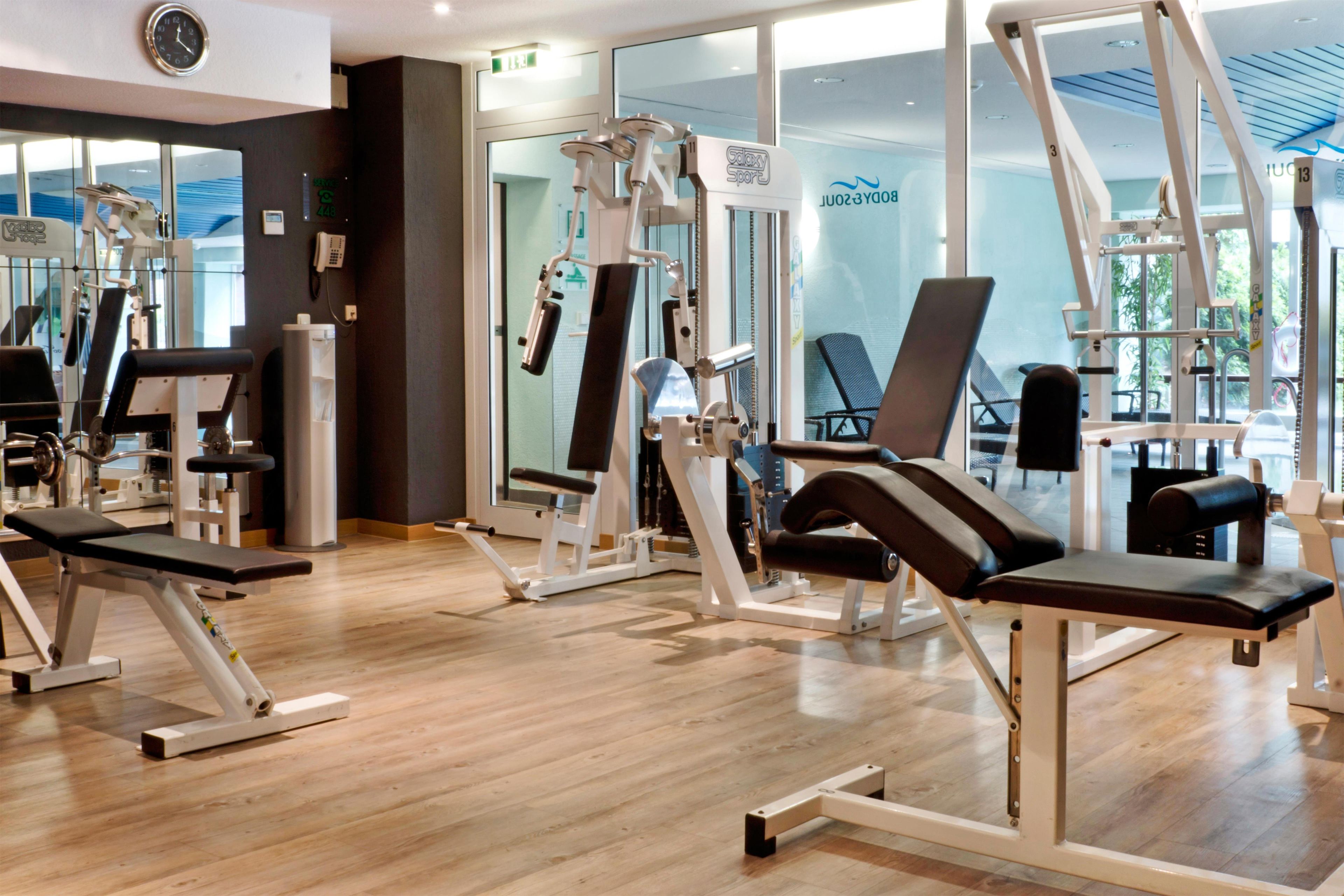 A gym with various exercise equipment, including treadmills and weight machines.