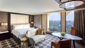 A hotel room with a large bed, a sofa, a dining table with chairs, and a balcony with a view. - InterContinental Dhaka by IHG (Dhaka)