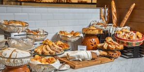 A buffet with various breads and pastries. - InterContinental Dhaka by IHG (Dhaka)