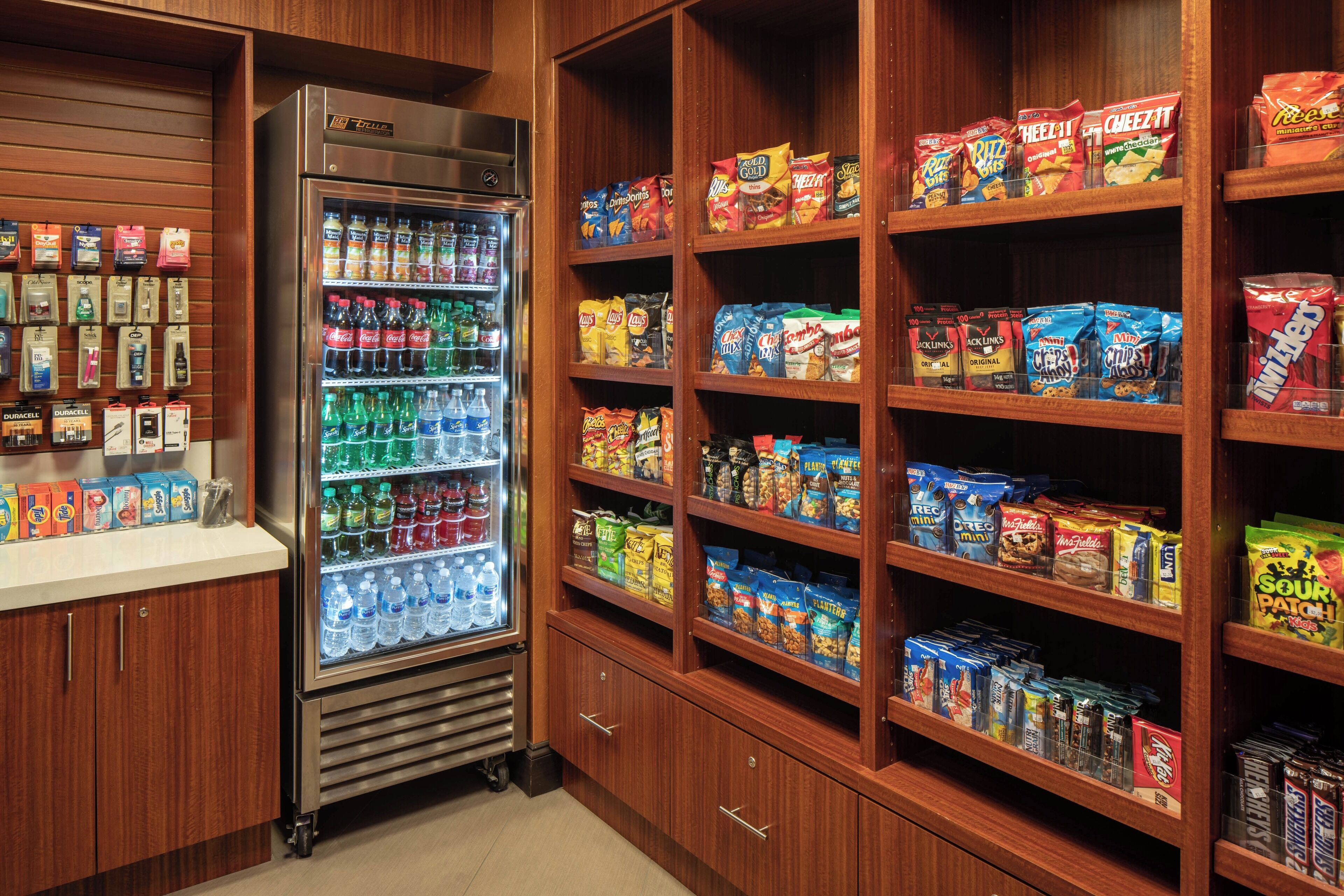 A snack and beverage display with various packaged snacks and bottled drinks.
