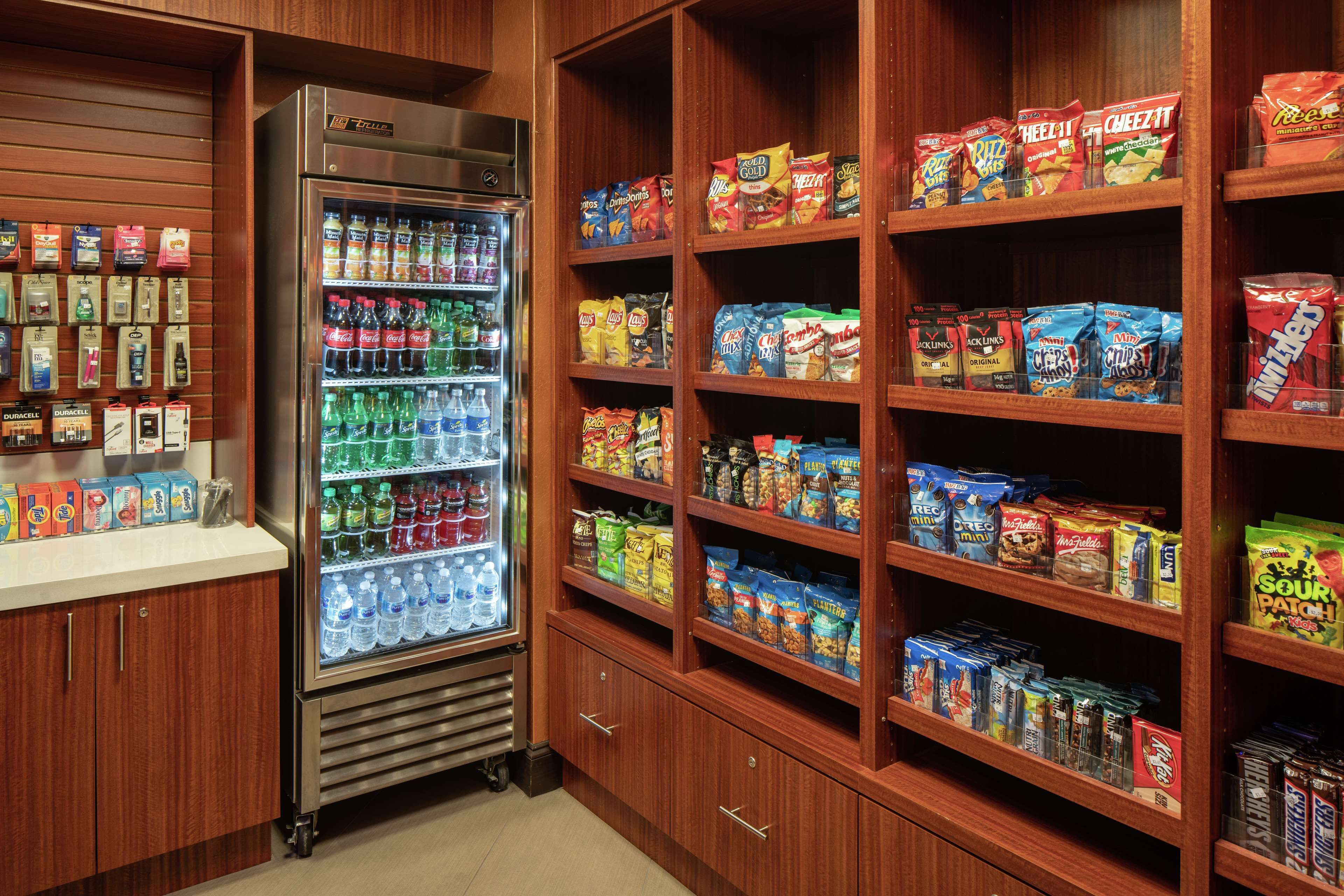 A snack and beverage display area with various packaged snacks and bottled drinks.