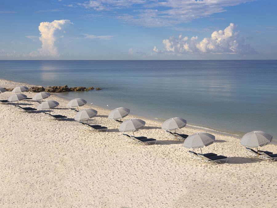 Private beach, white sand, sun loungers, beach umbrellas