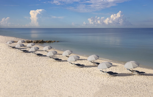 Plage privée, sable blanc, chaises longues, parasols