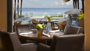 A dining area with a view of the beach and ocean. - Edgewater Beach Hotel (Naples)
