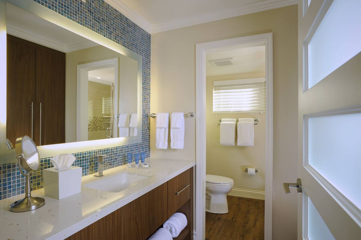 designer toiletries, hair dryer, bathrobes, slippers