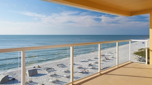 A beach view from a balcony with a clear sky, a sandy beach, and lounge chairs. - Edgewater Beach Hotel (Naples)