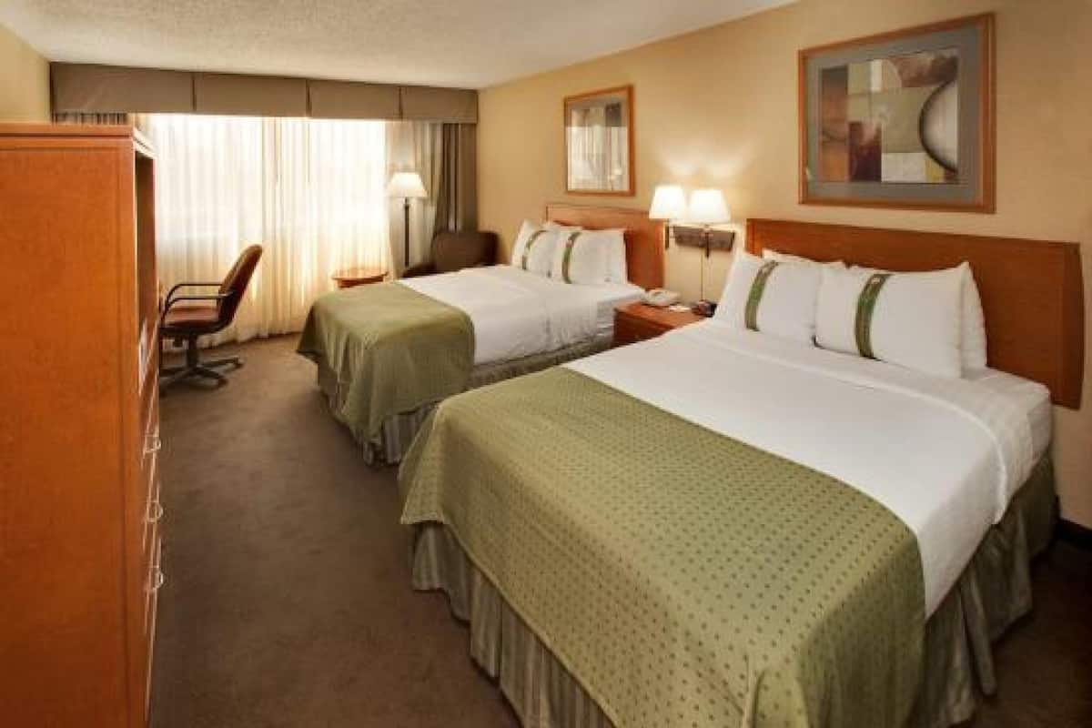 Premium bedding, pillow-top beds, laptop workspace, blackout curtains