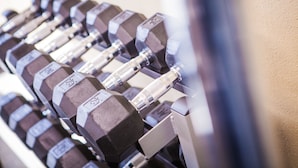 A set of dumbbells on a rack. - Holiday Inn Downtown - Mercy Area by IHG (Des Moines)
