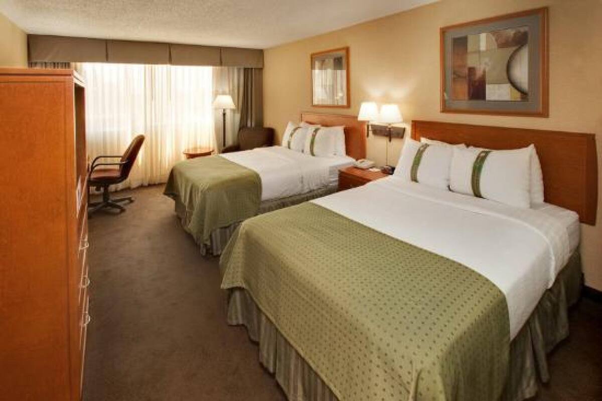 Premium bedding, pillow-top beds, laptop workspace, blackout curtains