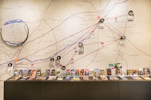 A map with marked locations and a display of books.