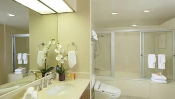A modern bathroom with a sink, mirror, and shower area.