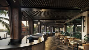 A spacious outdoor seating area with a curved counter, comfortable wicker chairs, and a tiled floor. - Disney's Polynesian Village Resort (Lake Buena Vista)