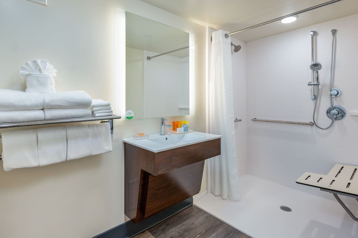 designer toiletries, hair dryer, towels, soap