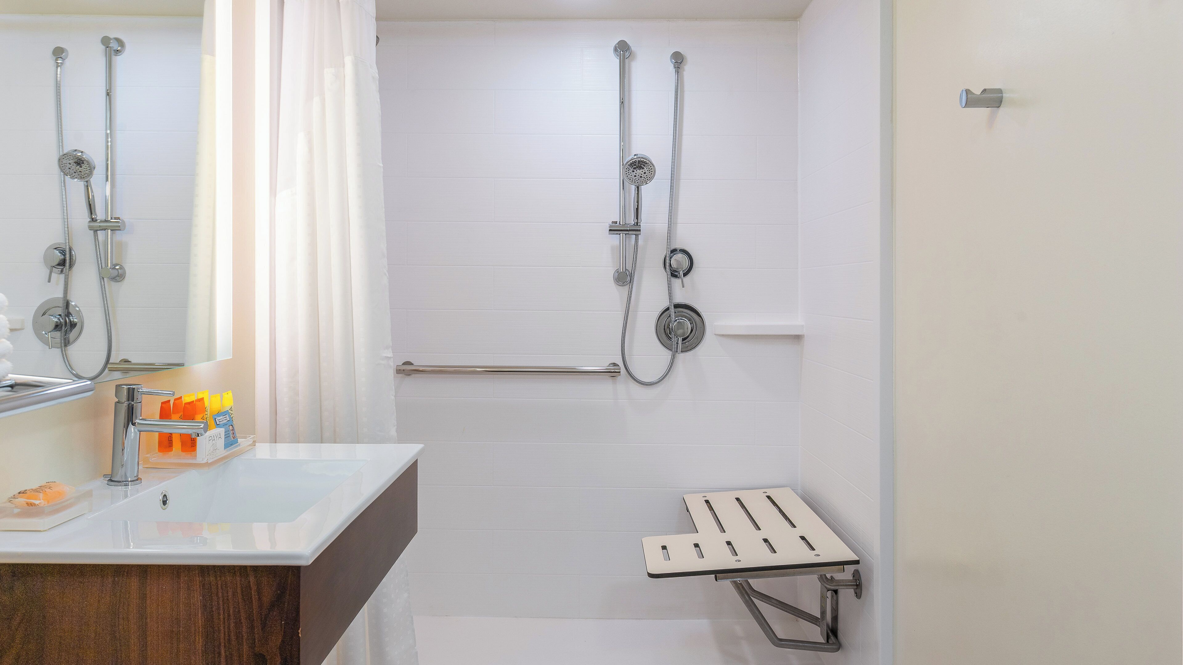 A modern bathroom with a shower, a toilet, and a sink.