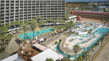 3 outdoor pools, open 8:00 AM to midnight, pool umbrellas, sun loungers at Holiday Inn Resort Panama City Beach, an IHG Hotel