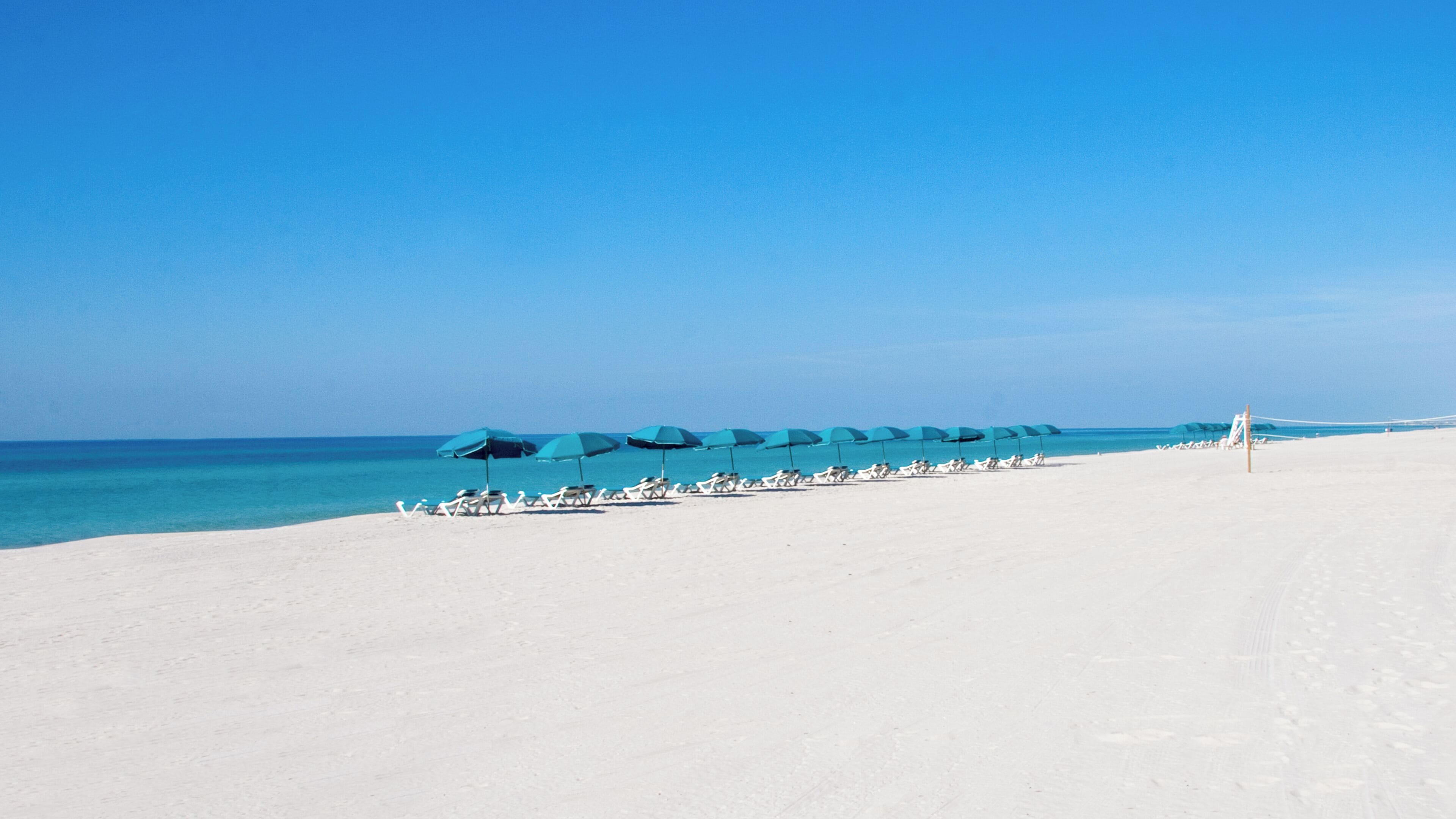 private beach, white sand, beach cabanas, sun-loungers