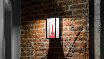 Un muro de ladrillo con un cuadro enmarcado de la Torre Eiffel.