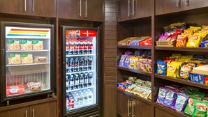 A snack and beverage vending area with a variety of snacks and Coca-Cola bottles. - Comfort Inn Chula Vista San Diego South (Chula Vista)