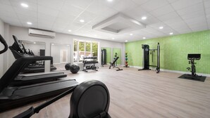 A gym with treadmills, elliptical machines, free weights, and exercise mats. - La Quinta Inn & Suites by Wyndham Myrtle Beach (Myrtle Beach)