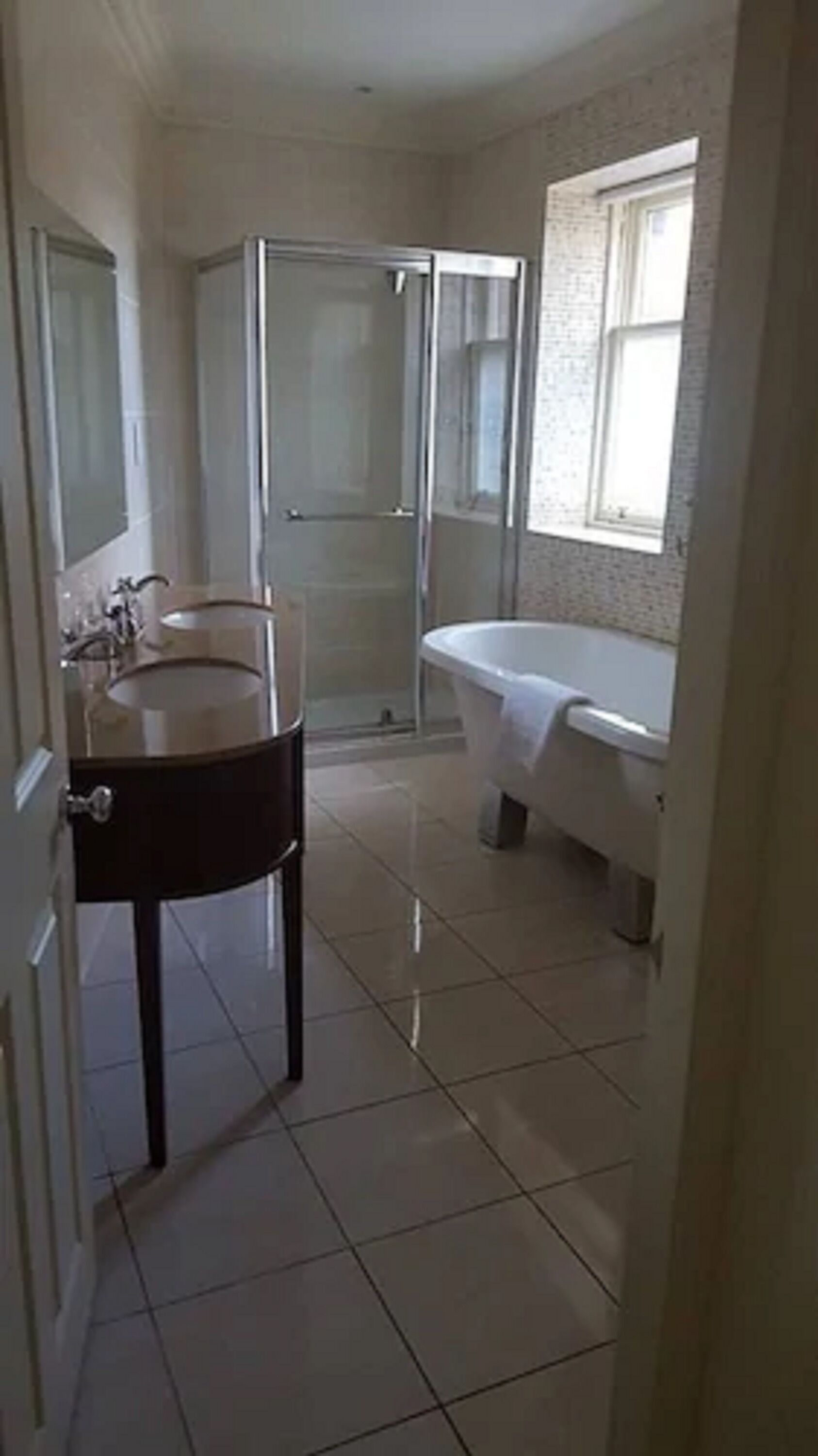 A bathroom with a shower, a sink, and a bathtub.