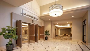 A hotel lobby with a tiled floor, a large chandelier, and a sign for the Arizona Ballroom. - Delta Hotels by Marriott Phoenix Mesa (Mesa)