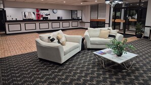 A reception area with two sofas, a coffee table, and a reception desk.