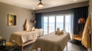 Enjoy a serene sea view from the comfort of this stylish room, featuring two single beds and a cozy seating area.