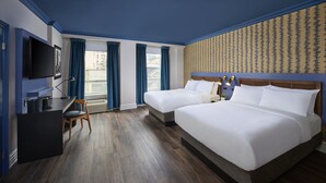 A hotel room with two beds, a desk, a chair, a TV, and a window with curtains. - Hotel Victoria (Toronto)