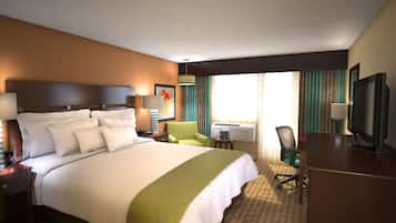 A hotel room with a large bed, a desk with a chair, a television, and an air conditioning unit.