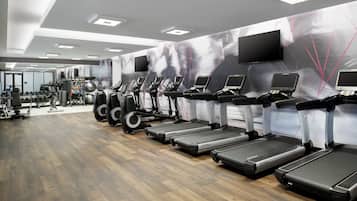 A gym with treadmills, ellipticals, and weight machines.