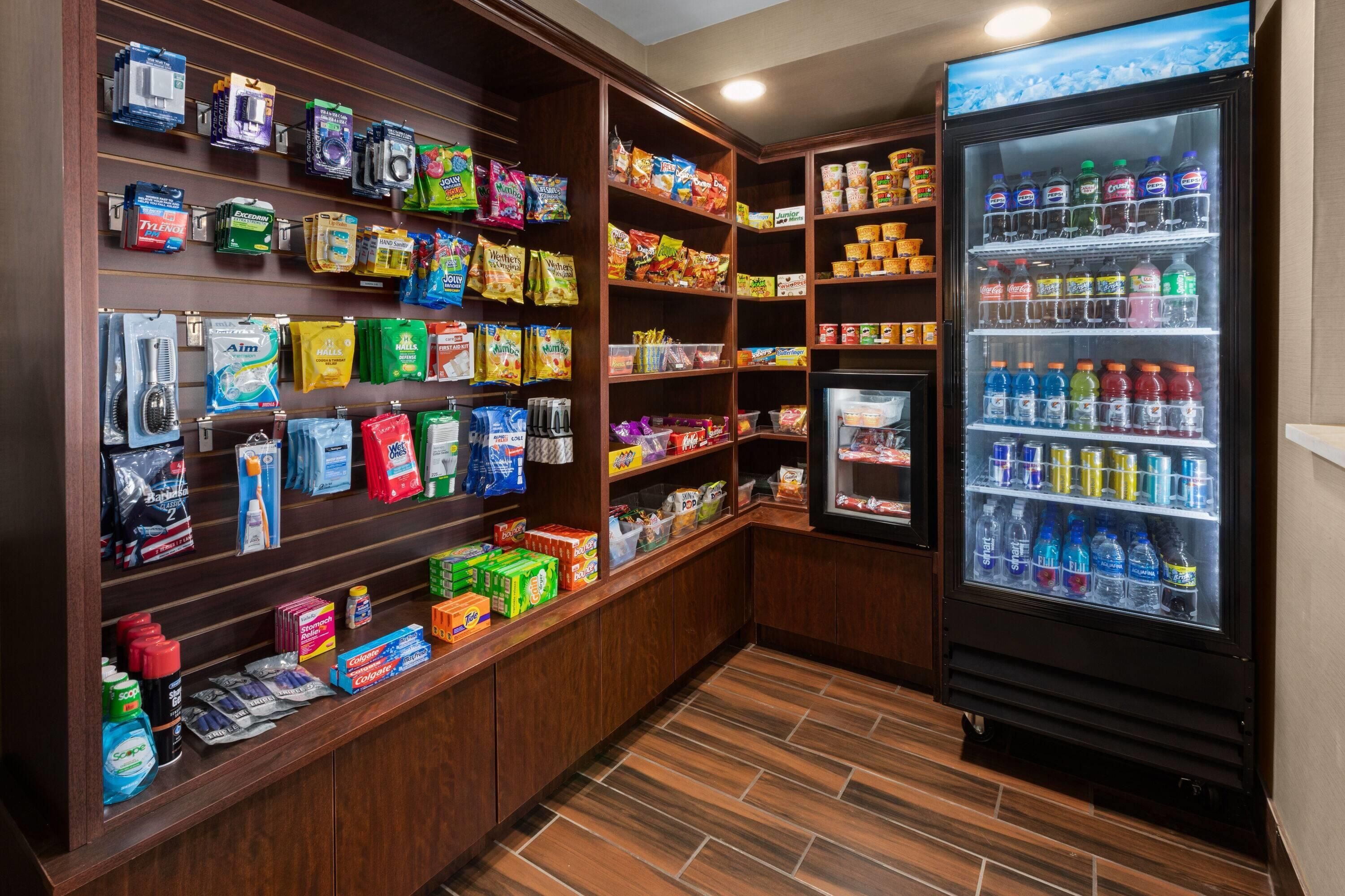 A well-stocked hotel pantry with various food items, snacks, and beverages.