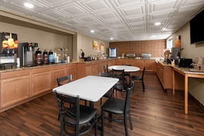A hotel kitchen with a coffee station, a refrigerator, and a microwave.