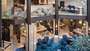 A multi-level hotel lobby with seating areas, a reception desk, and a dining area. - The Westin Grand Frankfurt (Frankfurt)