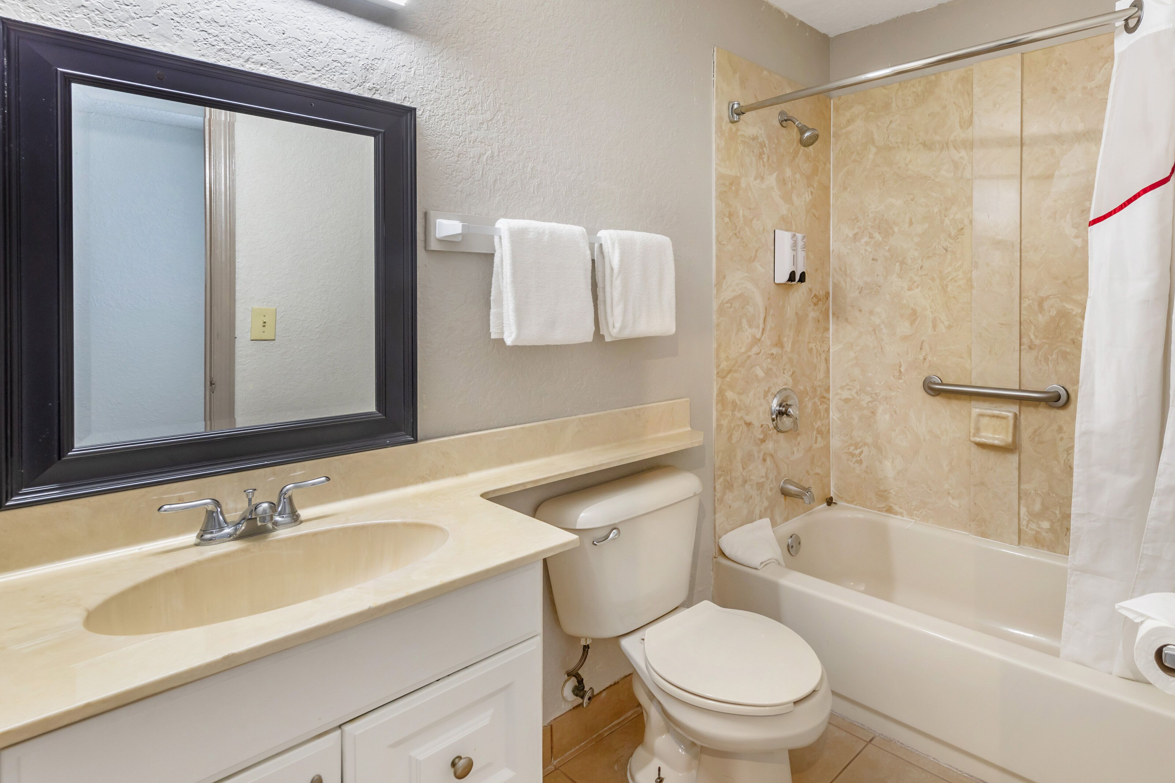 A bathroom with a sink, toilet, and bathtub.