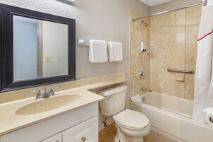 A bathroom with a sink, toilet, and bathtub.